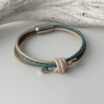 Lederarmband mit einem Knoten in taupe und petrol